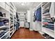 Walk-in closet with custom shelving and rod system for optimal storage and organization at 5075 Havenbrooke Ct, Cumming, GA 30040