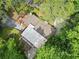 Aerial view of a home with a deck, surrounded by mature trees and lush greenery, offering privacy and shade at 609 Redwood Drive Dr, Woodstock, GA 30189