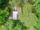 Aerial view of a home with a deck nestled in a wooded area, showcasing its natural surroundings at 609 Redwood Drive Dr, Woodstock, GA 30189