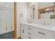 Updated bathroom with double sink vanity, marble countertops, black marble floors, and glass-enclosed shower at 609 Redwood Drive Dr, Woodstock, GA 30189