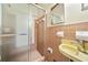 Bathroom features a glass enclosed shower, tiled walls, and a vanity with sink at 609 Redwood Drive Dr, Woodstock, GA 30189
