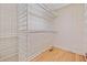 Empty walk-in closet with white wire shelving and hardwood floors at 609 Redwood Drive Dr, Woodstock, GA 30189