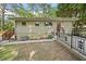 Ranch-style home showing accessible ramp, red entry door, and low profile landscaping at 609 Redwood Drive Dr, Woodstock, GA 30189