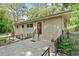 Single story house with red entry door, metal railing, and mature trees providing shade at 609 Redwood Drive Dr, Woodstock, GA 30189