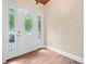 Bright foyer featuring hardwood floors, a decorative door with glass panels, and neutral walls at 609 Redwood Drive Dr, Woodstock, GA 30189