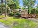 Charming single-story home with a well-maintained lawn and mature trees enhancing its curb appeal at 609 Redwood Drive Dr, Woodstock, GA 30189