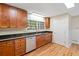 Kitchen features wood cabinets, black countertops, stainless steel dishwasher, and hardwood floors at 609 Redwood Drive Dr, Woodstock, GA 30189
