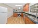 Bright kitchen with stainless appliances, granite counters, window, and hardwood floors at 609 Redwood Drive Dr, Woodstock, GA 30189