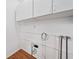 A functional laundry room with white cabinets and essential utility connections at 609 Redwood Drive Dr, Woodstock, GA 30189