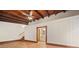 Spacious living room with wood floors, vaulted ceilings with exposed beams, and bathroom access at 609 Redwood Drive Dr, Woodstock, GA 30189