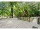 Outdoor patio area featuring mature trees and landscaping at 609 Redwood Drive Dr, Woodstock, GA 30189