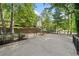 Backyard patio area with metal fencing and mature trees at 609 Redwood Drive Dr, Woodstock, GA 30189