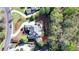 Aerial view of a home with mature trees, landscaping, and a circular driveway at 10125 Brixton Pl, Suwanee, GA 30024