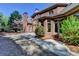 Brick home exterior featuring a large backyard with mature trees, and a covered patio area, perfect for outdoor entertaining at 10125 Brixton Pl, Suwanee, GA 30024