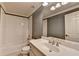 Cozy bathroom featuring a shower over tub, white vanity, and a neutral color scheme at 10125 Brixton Pl, Suwanee, GA 30024