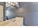 Bathroom featuring a vanity with a single sink, a large mirror, and a soft gray color scheme at 10125 Brixton Pl, Suwanee, GA 30024