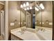 Bathroom featuring a double sink vanity with a mirrored wall and decorative lighting fixtures at 10125 Brixton Pl, Suwanee, GA 30024
