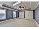 Bedroom with two large closets, windows providing natural light, tray ceiling and blue walls at 10125 Brixton Pl, Suwanee, GA 30024
