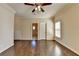 Bedroom featuring wood floors, a ceiling fan, and an adjacent bathroom for comfort and convenience at 10125 Brixton Pl, Suwanee, GA 30024