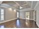 Bedroom featuring tray ceilings, hardwood floors, and large windows, with neutral tones and an inviting, calm atmosphere at 10125 Brixton Pl, Suwanee, GA 30024