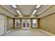 Versatile bonus room with recessed lighting and neutral walls, perfect for customization with access to the outside at 10125 Brixton Pl, Suwanee, GA 30024