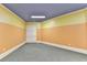 Versatile bonus room with neutral color scheme, carpeted floors, storage cabinets, and ample space for various activities at 10125 Brixton Pl, Suwanee, GA 30024