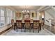 Formal dining room features a large table, decorative rug and plantation shutters at 10125 Brixton Pl, Suwanee, GA 30024