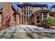 A brick home exterior showcases a well-maintained yard, large windows, and a classic design at 10125 Brixton Pl, Suwanee, GA 30024