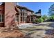 A brick home showcasing a patio and manicured lawn at 10125 Brixton Pl, Suwanee, GA 30024
