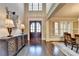 Elegant foyer with hardwood floors, dining room access, and double front door at 10125 Brixton Pl, Suwanee, GA 30024