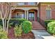 Covered front porch entrance features a brick staircase and columns at 10125 Brixton Pl, Suwanee, GA 30024