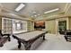 Game room with a pool table, a wet bar, and an adjacent workout room for entertainment and fitness at 10125 Brixton Pl, Suwanee, GA 30024