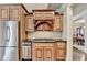 Gourmet kitchen with stainless steel appliances, custom cabinets, and a view into a fireplace room at 10125 Brixton Pl, Suwanee, GA 30024
