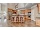 Open kitchen features stainless steel appliances, custom wood cabinets, and a large island with bar seating at 10125 Brixton Pl, Suwanee, GA 30024