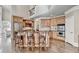 Gourmet kitchen features stainless steel appliances, a large island with seating, and custom wood cabinetry at 10125 Brixton Pl, Suwanee, GA 30024