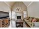 Cozy living room with a fireplace, large windows, and comfortable seating, creating a warm and inviting atmosphere for relaxing at 10125 Brixton Pl, Suwanee, GA 30024