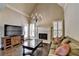 Cozy living room with a fireplace, hardwood floors, and a comfortable sofa, creating a warm and inviting atmosphere at 10125 Brixton Pl, Suwanee, GA 30024
