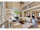 Bright living room boasts large windows, fireplace, hardwood floors, and elegant white furniture at 10125 Brixton Pl, Suwanee, GA 30024