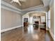 Large living room with hardwood floors, tray ceiling, and ample natural light, creating an inviting and comfortable space at 10125 Brixton Pl, Suwanee, GA 30024