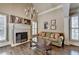 Living room with a fireplace, hardwood floors, and a comfortable sofa, offering a cozy and inviting space to relax and unwind at 10125 Brixton Pl, Suwanee, GA 30024
