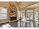 Living space with hardwood floors, stone fireplace, and sunlit windows for natural lighting at 10125 Brixton Pl, Suwanee, GA 30024