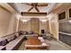 Media room showcasing a large leather couch, wood coffee table, speakers, and entertainment center at 10125 Brixton Pl, Suwanee, GA 30024