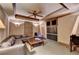 Media room with built-in cabinets, ceiling fan, recessed lighting, comfortable leather seating, and a large screen TV at 10125 Brixton Pl, Suwanee, GA 30024