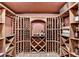 Spacious wine cellar with custom wooden racks, tile flooring, and ambient lighting, perfect for the wine enthusiast at 10125 Brixton Pl, Suwanee, GA 30024