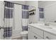 Bathroom featuring a single sink vanity, toilet, and shower with blue patterned curtain at 242 Crestbrook Ln, Dallas, GA 30157