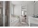 Bathroom featuring a soaking tub with tiled walls, shower, and double sink vanity at 242 Crestbrook Ln, Dallas, GA 30157