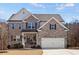 Charming two-story brick home featuring a welcoming front porch and attached two-car garage at 242 Crestbrook Ln, Dallas, GA 30157