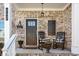 Inviting front porch with rocking chairs, flower pots, and a charming welcome sign at 242 Crestbrook Ln, Dallas, GA 30157