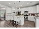 Bright, open kitchen with white cabinets, stainless steel appliances, and center island at 242 Crestbrook Ln, Dallas, GA 30157