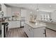 Open concept kitchen with island, stainless steel appliances, and view to living room at 242 Crestbrook Ln, Dallas, GA 30157